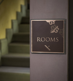 Hotel room number signs in crystal glass and burnished brass